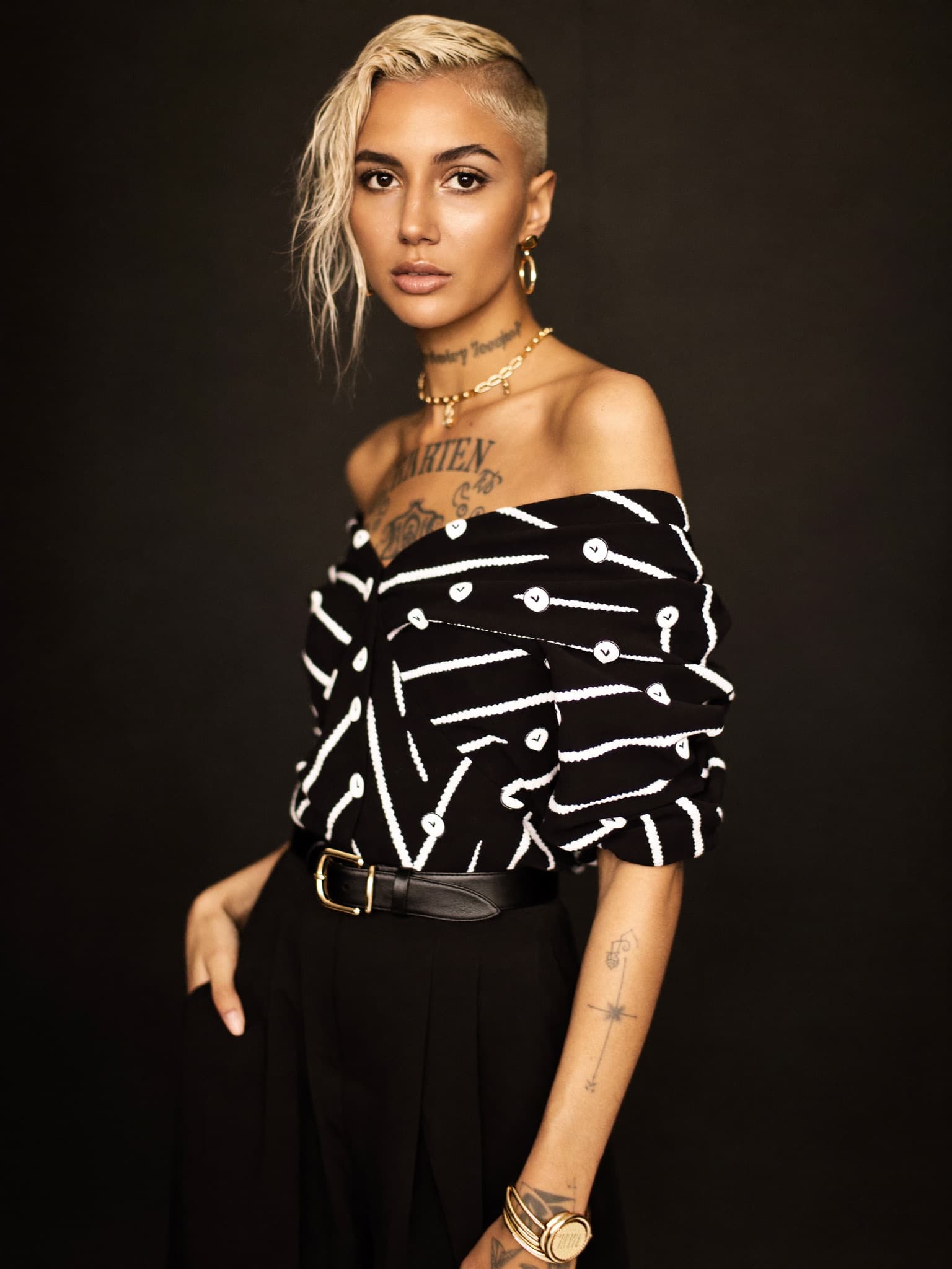 A confident creator photographed for her page — the asset an operator builds and runs